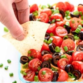 Learn how to make Classic 7-Layer Taco Dip with this simple recipe. Made with fresh ingredients, this is the BEST Mexican layer dip and is perfect for any party! www.wellplated.com