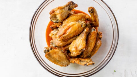 mix buffalo sauce on crispy chicken wings