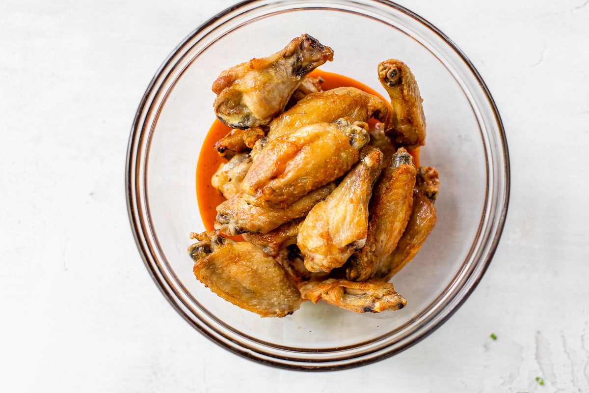 mix buffalo sauce on crispy chicken wings