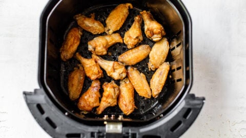 air fryer chicken wings spread in basket