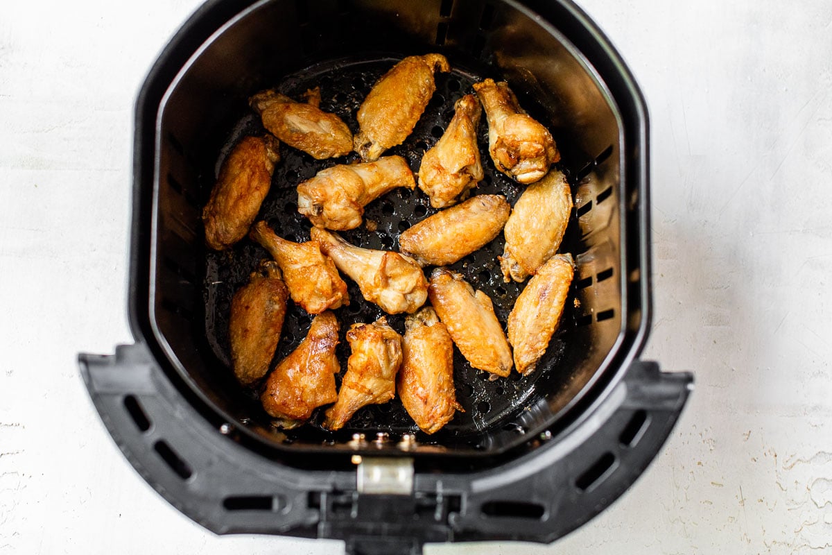 air fryer chicken wings spread in basket