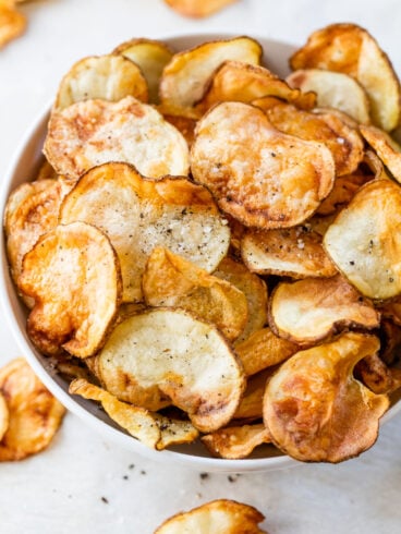 A bowl of air fryer potato chips with seasonings