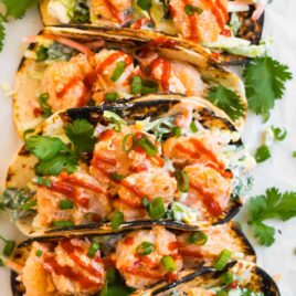 Bang bang shrimp tacos on a white counter