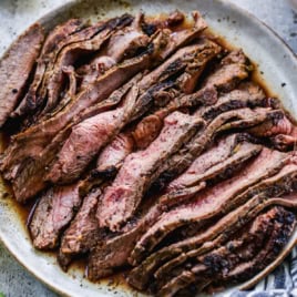 Overhead view of sliced carne asada on platter