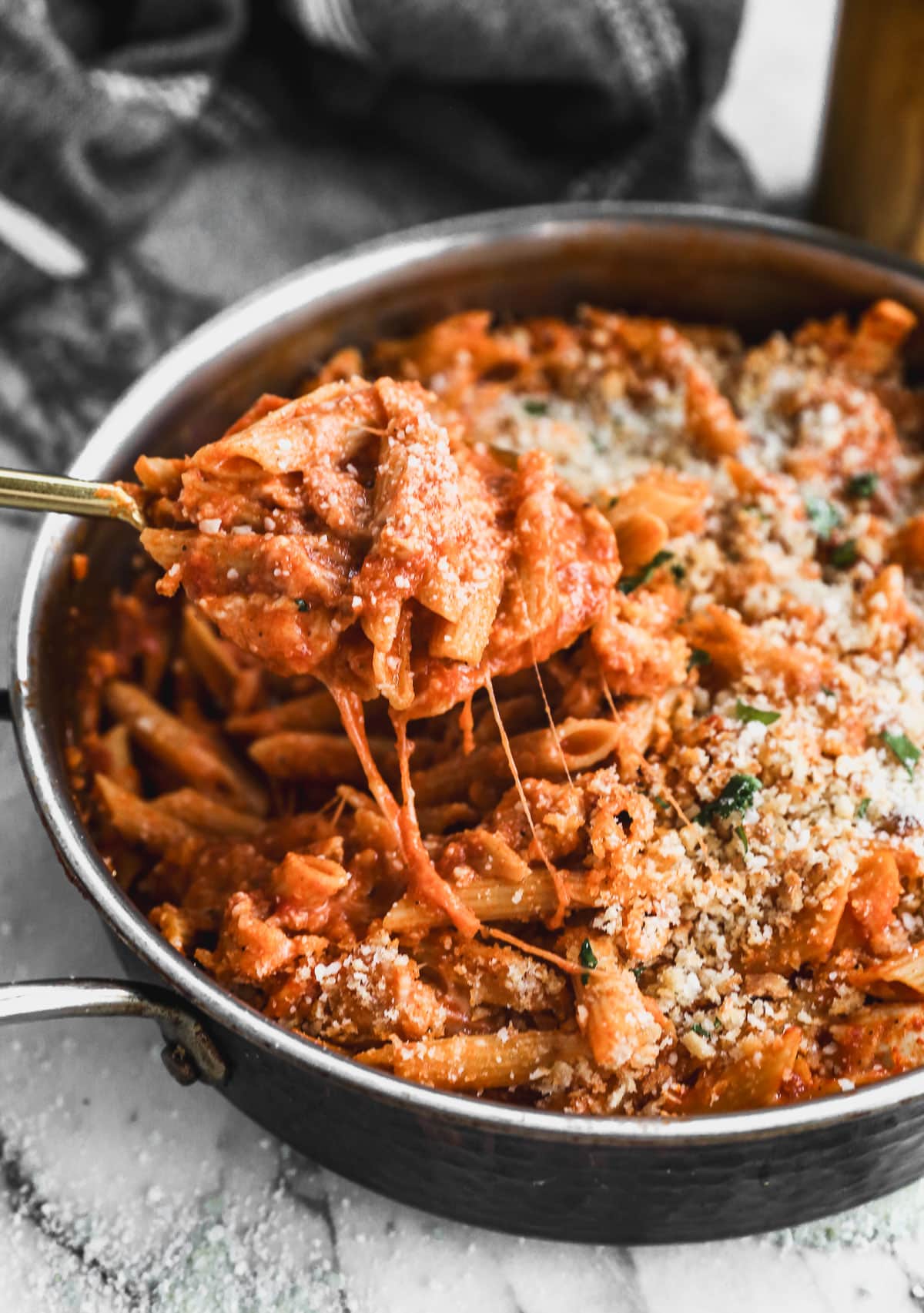 easy chicken parmesan pasta recipe being lifted from pan with spoon