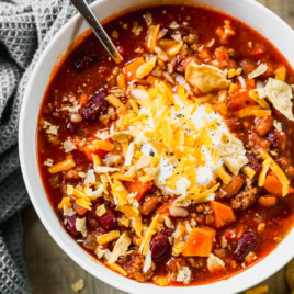 Instant Pot chili in bowl topped with sour cream and cheese
