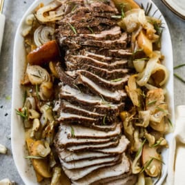 Pork roast recipe on platter with apples