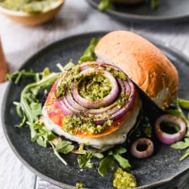 Grilled vegetarian portobello mushroom burger on plate with toppings