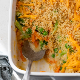 Vegetable casserole in baking dish with serving spoon