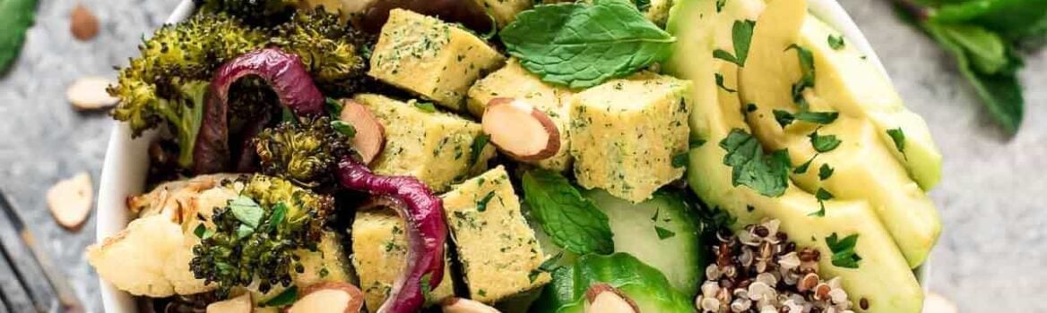 a roasted veggie buddha bowl with tahini dressing, tofu and quinoa