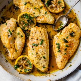 chicken francaise in a skillet with butter