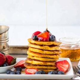 Fluffy low carb coconut flour pancakes! Light, tender pancakes made with coconut flour. High protein and easy to freeze for healthy breakfasts. Add banana, lemon, or any of your favorite toppings! #lowcarb #coconutflourpancakes #healthy #coconutflour