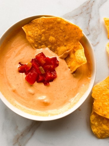 cottage cheese queso in a bowl with tortilla chips