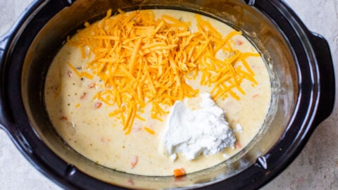 stirring greek yogurt and cheese into easy crockpot potato soup