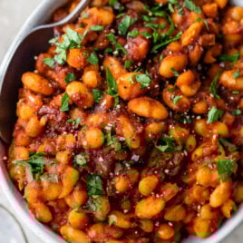 Healthy Baked Beans easy in a bowl with parsley and spoon