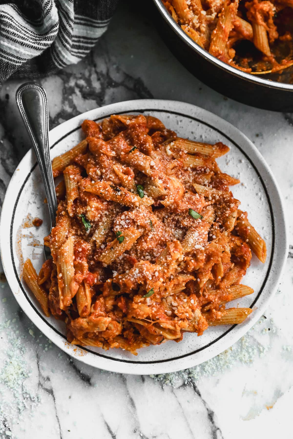 chicken parmesan pasta on plate with fork