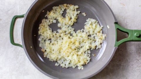 sauted onions in a skillet is the first step to easy crockpot potato soup
