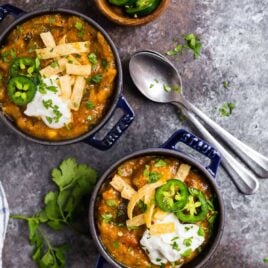 Two bowls of green chili with jalapeno