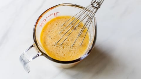 whisking up eggs to make a quiche recipe