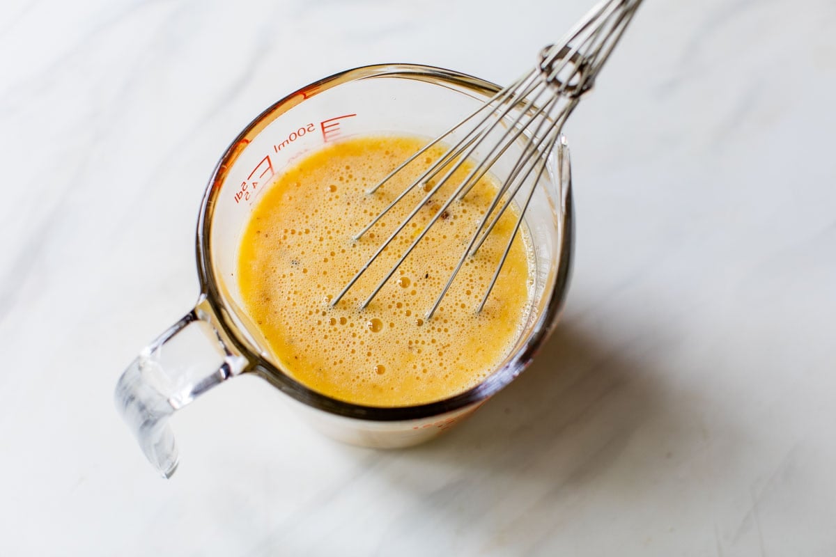 whisking up eggs to make a quiche recipe