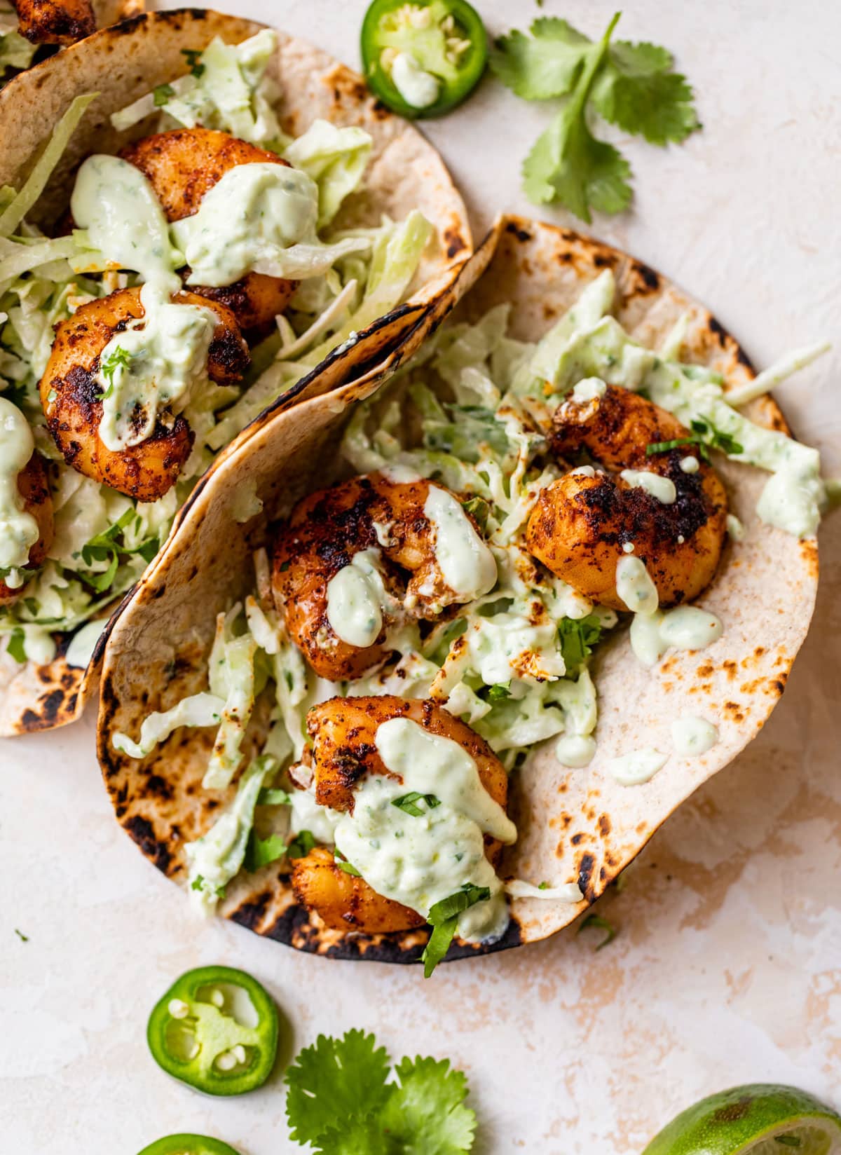 Shrimp topped with a creamy taco slaw and extra shrimp taco sauce to make a delicious and healthy shrimp taco.