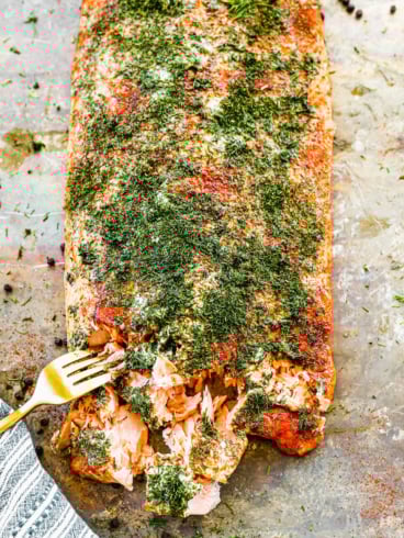 a side of smoked salmon being flaked with a fork