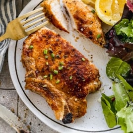 Fried pork chops cut on plate
