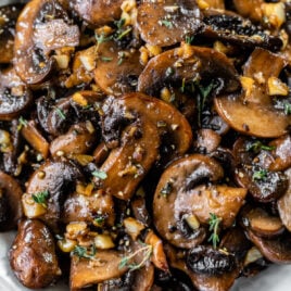 Sauteed mushrooms piled into a white bowl