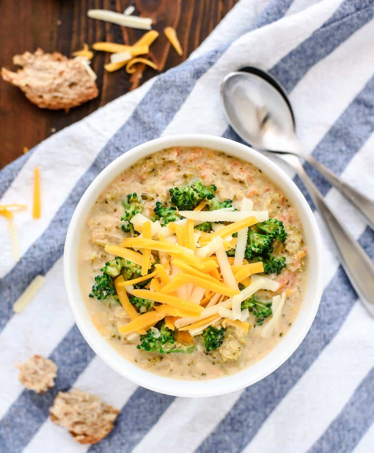 a white soup bowl filled with Slow Cooker Broccoli and Cheese Soup