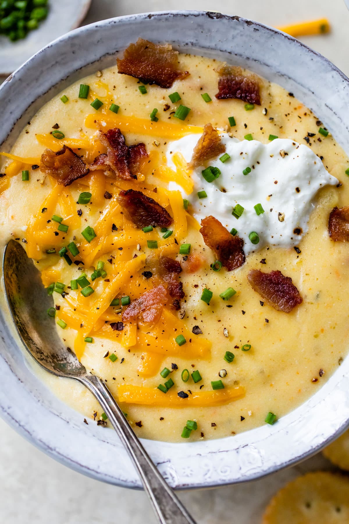 a bowl with loaded crockpot potato soup without heavy cream