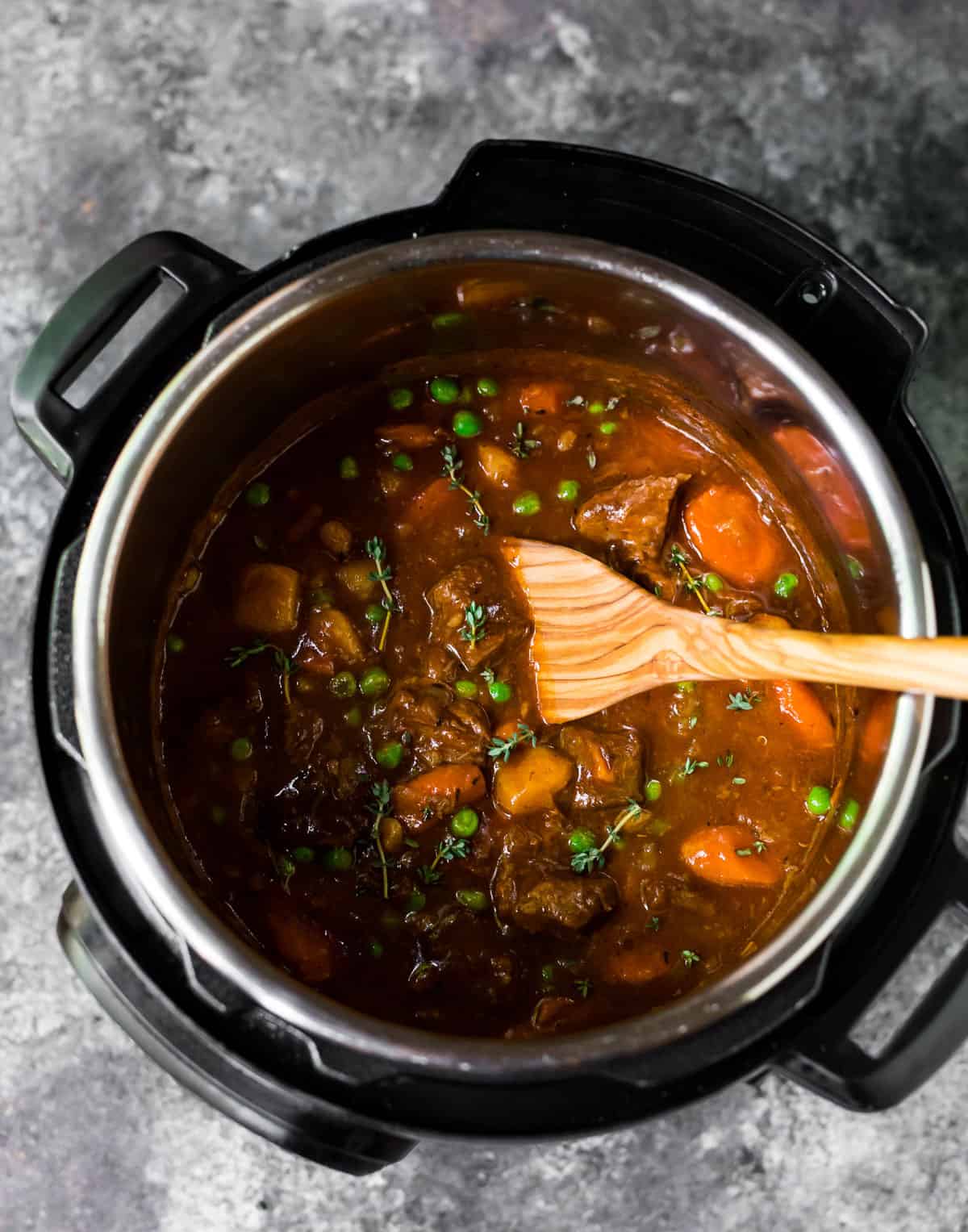 A pressure cooker with meat and vegetables for the BEST instant pot beef stew