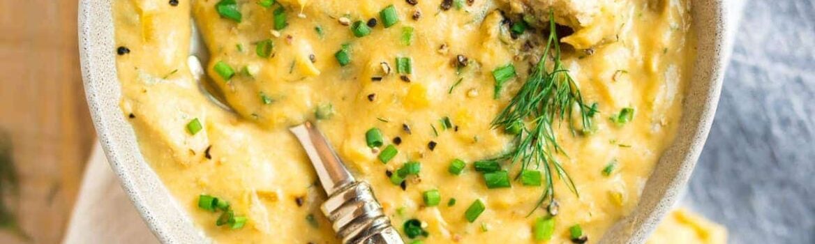 A bowl of Creamy Vegan Potato Leek Soup with bread