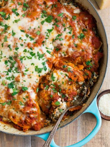 An easy, healthy skillet lasagna with Italian sausage, butternut squash, ricotta, and spinach. Everything cooks in ONE pot (cast iron or regular) for easy clean up!