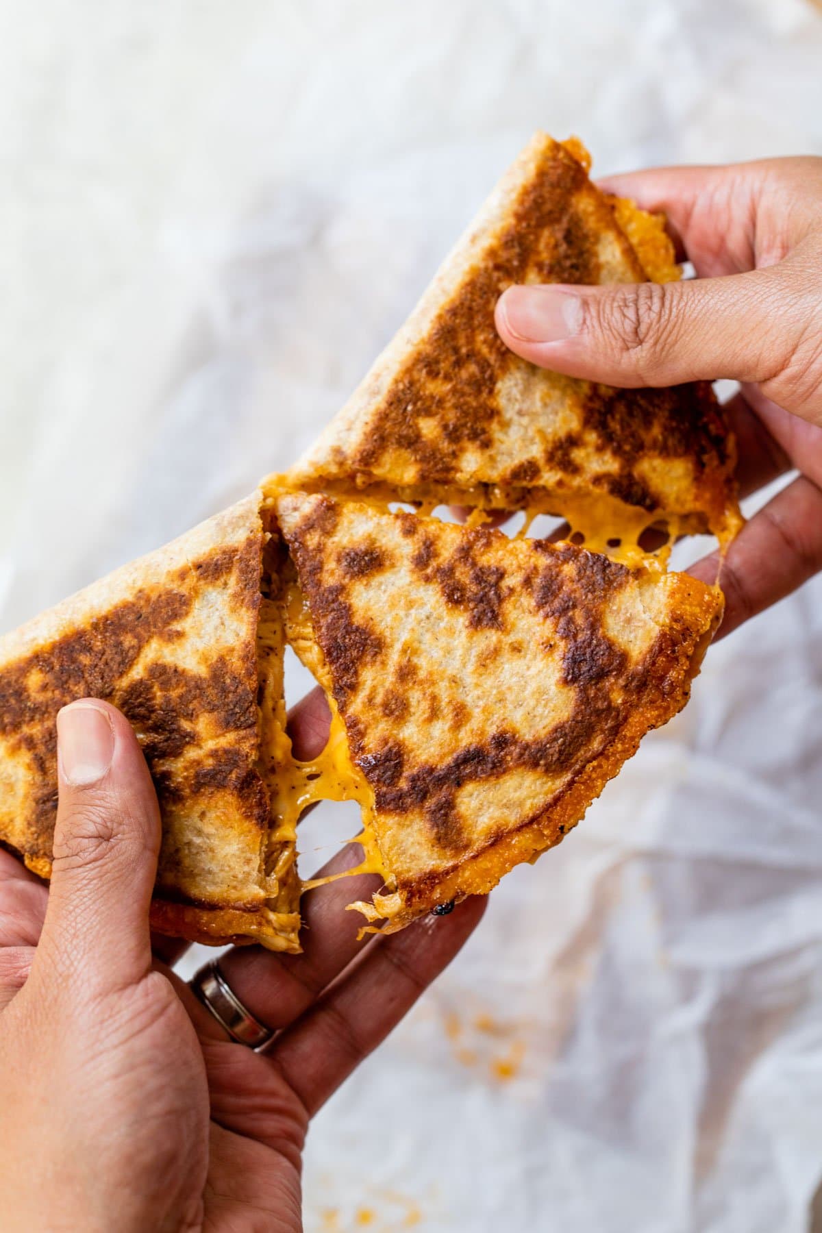 A chicken quesadilla being pulled apart