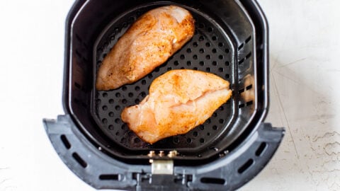 Two raw pieces of meat in a basket