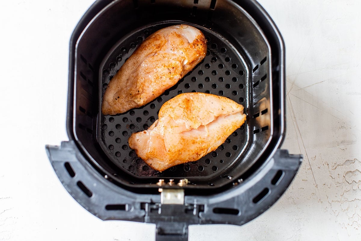 Two raw pieces of meat in a basket