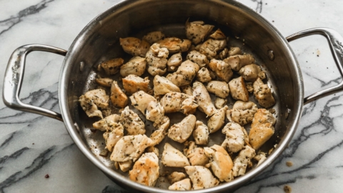 cooked chicken pieces in skillet