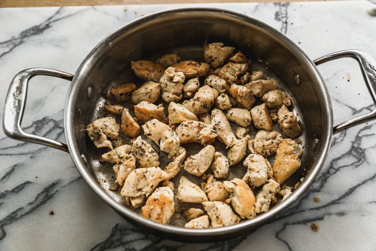 cooked chicken pieces in skillet