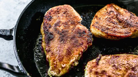 Chicken breasts in a skillet for cowboy chicken
