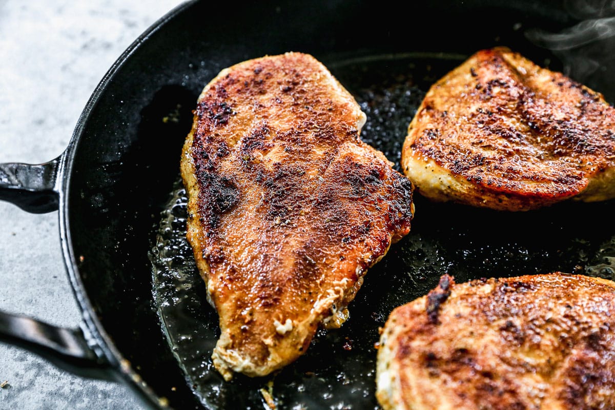 Chicken breasts in a skillet for cowboy chicken