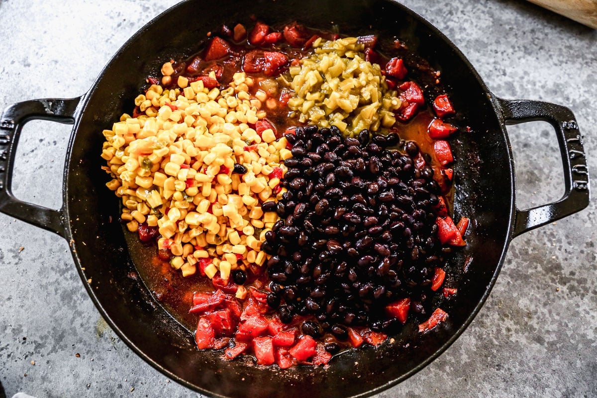 Corn, beans, tomatoes, and green chiles in a skillet