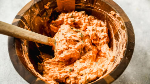 Stirring together ingredients for healthy Buffalo chicken dip