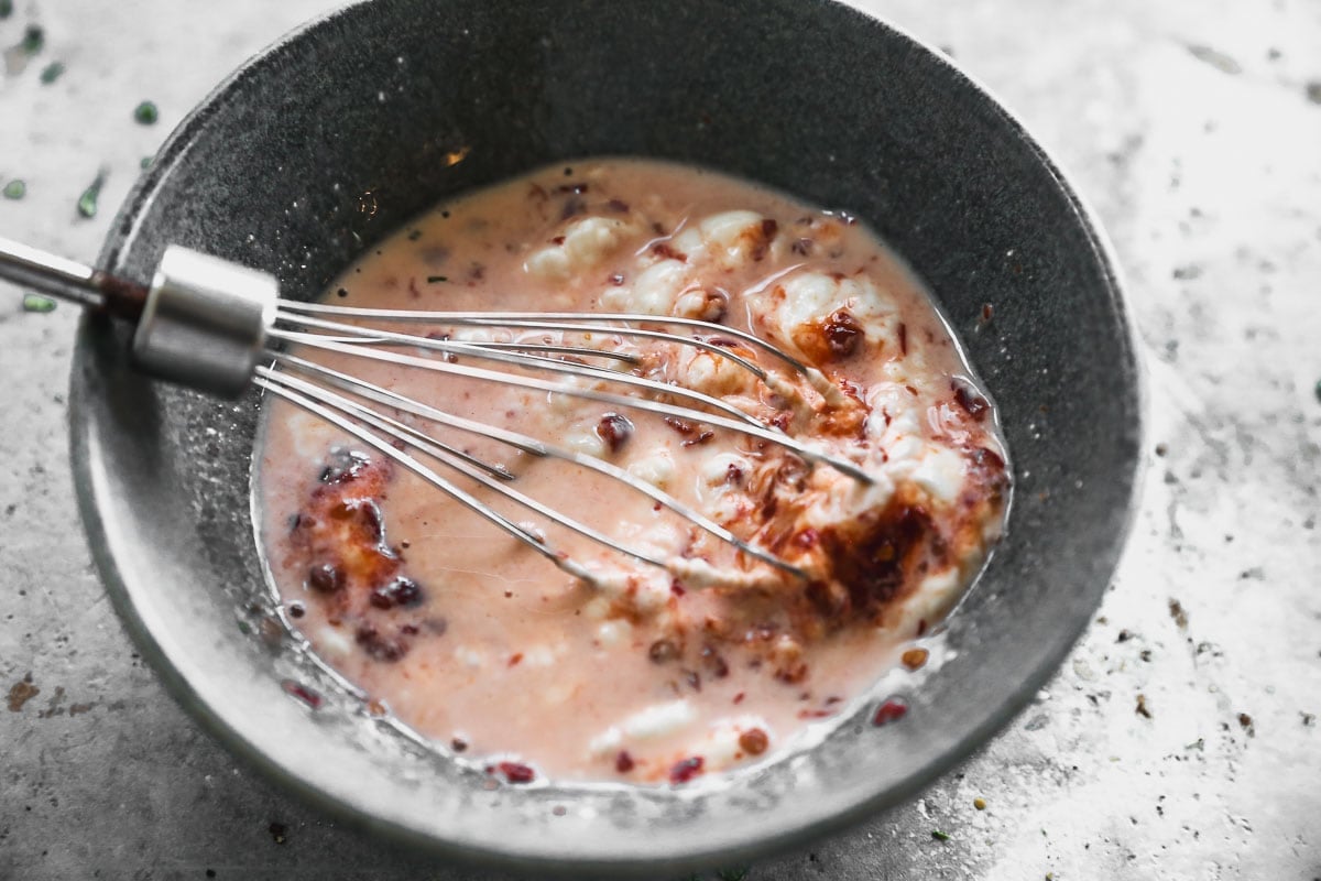 whisking creamy sauce for salmon bowls