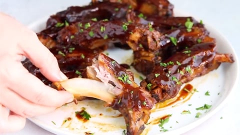 fall off the bone tender crockpot ribs being pulled apart easily with fingers