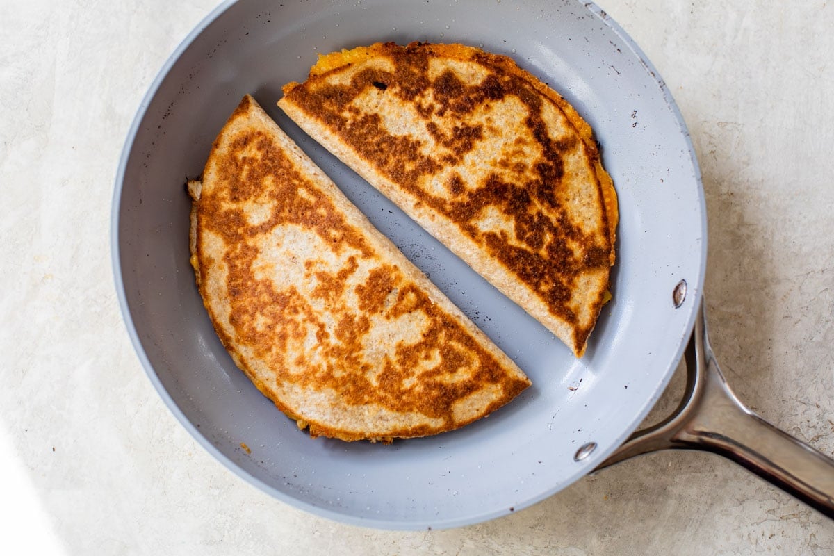 chicken quesadillas being cooked in a skillet
