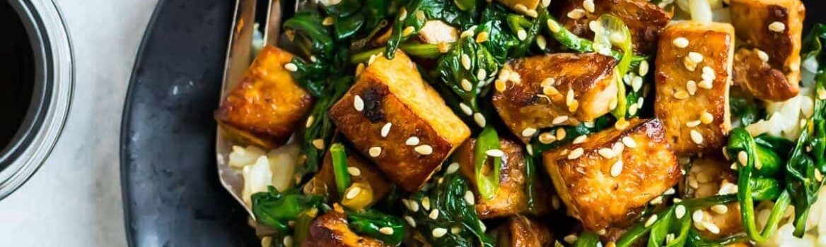 Easy Sesame Tofu Stir Fry. Crispy tofu with spinach, broccoli, or any fresh vegetables you love. This vegan recipe is packed with flavor in a simple, delicious Asian garlic ginger sauce. Serve with rice or noodles.