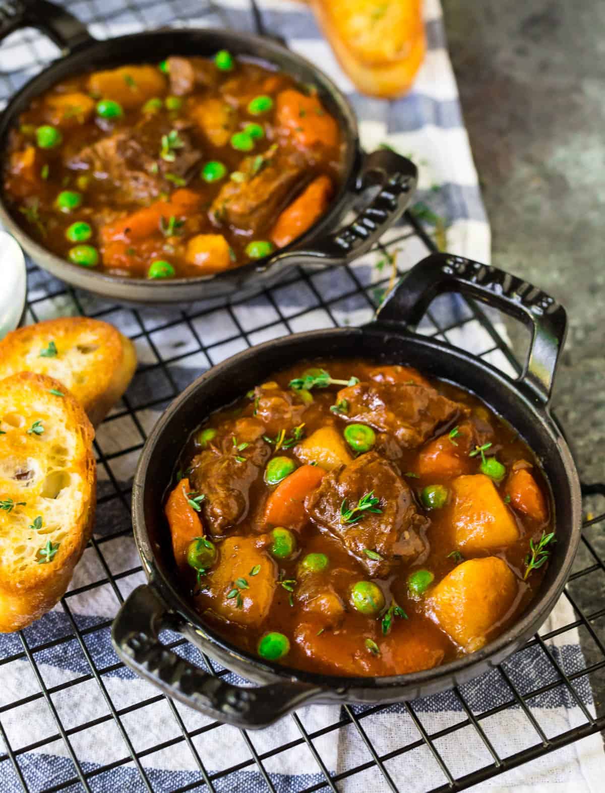 Two bowls of instant pot beef stew soup with bread