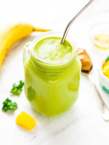 Banana Kale Pineapple Smoothie in mug with straw
