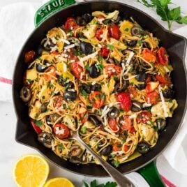A skillet of Mediterranean pasta with olives and tomatoes