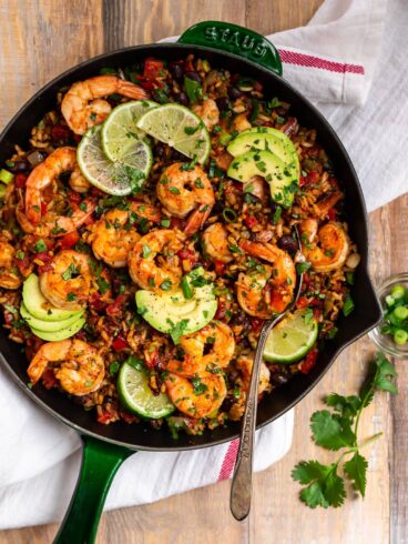 Healthy Mexican Shrimp and Rice. Easy one skillet dinner that's full of spicy Mexican flavor! Juicy shrimp, colorful veggies, whole grain brown rice, and black beans make this a true all-in-one meal.